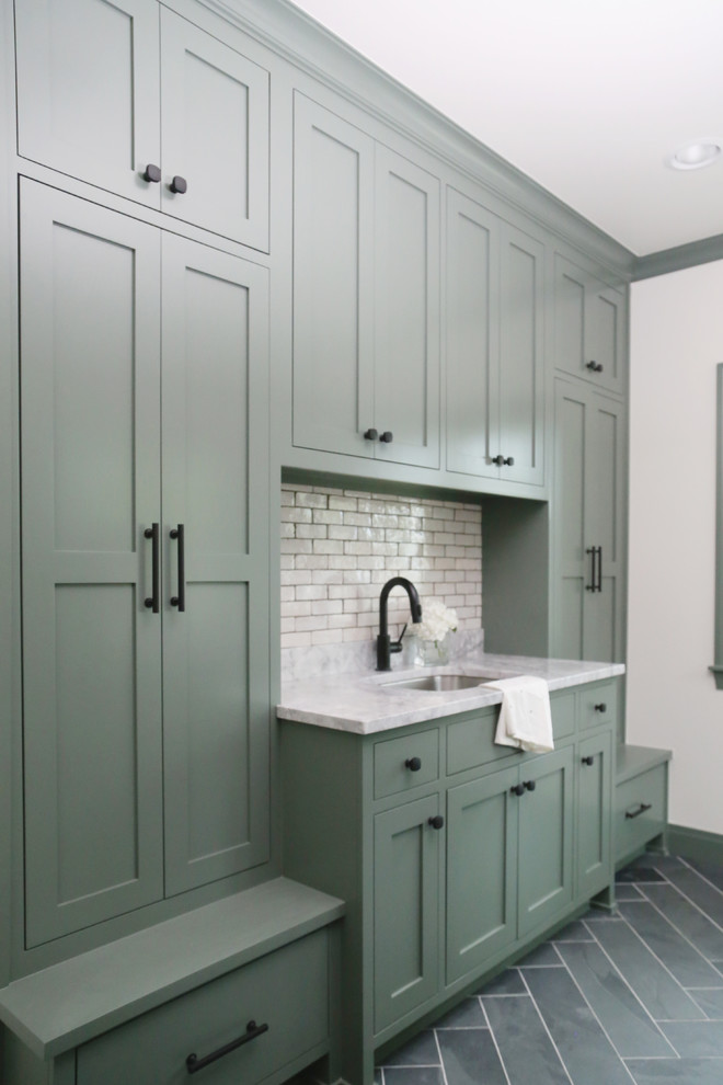 Mid-sized transitional galley utility room in Other with an undermount sink, shaker cabinets, green cabinets, marble benchtops, white walls, vinyl floors, a side-by-side washer and dryer, grey floor and grey benchtop.