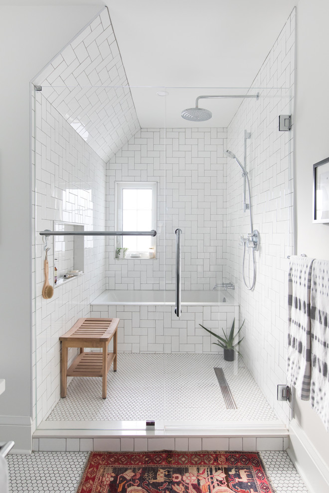 Photo of a mid-sized transitional master bathroom in Toronto with recessed-panel cabinets, black cabinets, an alcove shower, a two-piece toilet, white tile, subway tile, white walls, mosaic tile floors, an undermount sink, quartzite benchtops, white floor, a hinged shower door and white benchtops.