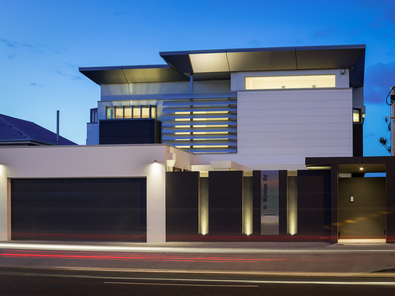 Photo of a large modern three-storey glass white exterior in Brisbane.
