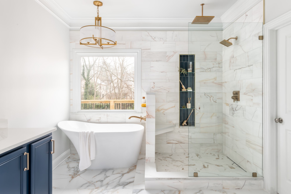 Inspiration for a medium sized classic ensuite bathroom in Atlanta with recessed-panel cabinets, blue cabinets, a freestanding bath, a corner shower, a two-piece toilet, white tiles, marble tiles, white walls, porcelain flooring, a submerged sink, engineered stone worktops, white floors, an open shower, white worktops, a wall niche, double sinks and a built in vanity unit.