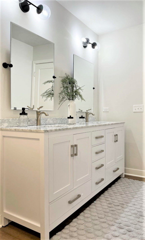 Design ideas for a small transitional kids bathroom in Chicago with shaker cabinets, white cabinets, an alcove shower, a two-piece toilet, vinyl floors, an undermount sink, marble benchtops, brown floor, a sliding shower screen, white benchtops, a double vanity and a freestanding vanity.