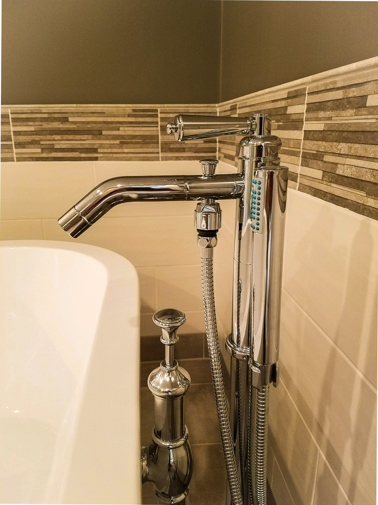 Large transitional master multicolored tile and ceramic tile porcelain tile and gray floor freestanding bathtub photo with shaker cabinets, white cabinets, a two-piece toilet, gray walls, an undermount sink, granite countertops and a hinged shower door