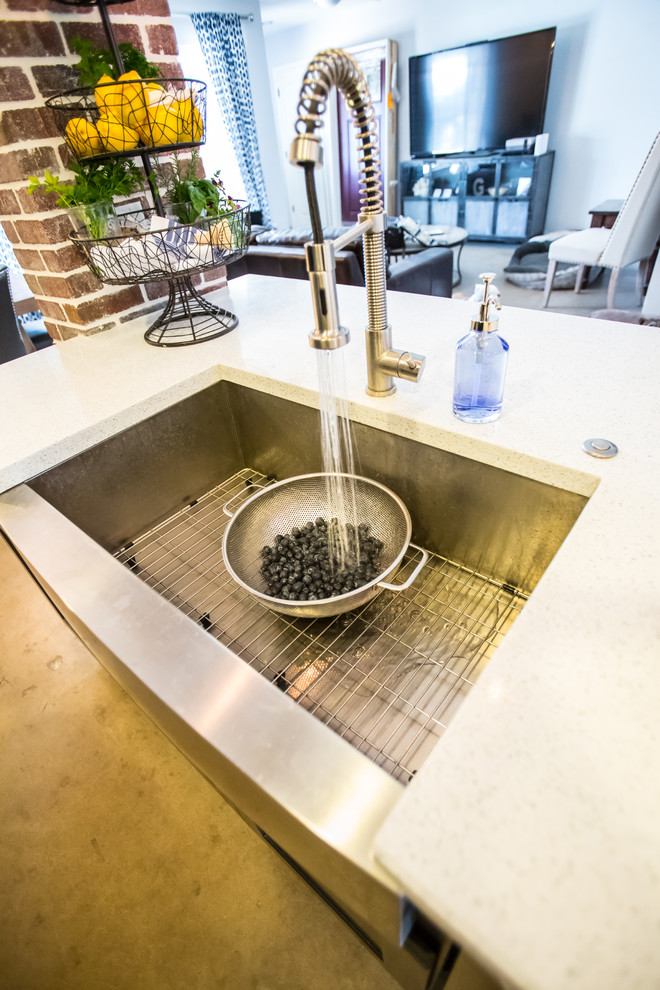 Inspiration for a mid-sized rustic single-wall concrete floor and gray floor open concept kitchen remodel in Phoenix with dark wood cabinets, blue backsplash, stainless steel appliances, an island, an undermount sink, shaker cabinets, quartzite countertops and glass tile backsplash