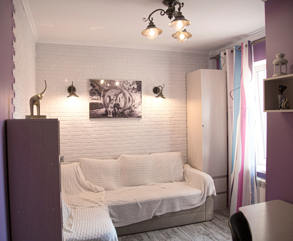 This is an example of a medium sized industrial study in Moscow with purple walls, laminate floors, a freestanding desk, grey floors, brick walls and a feature wall.