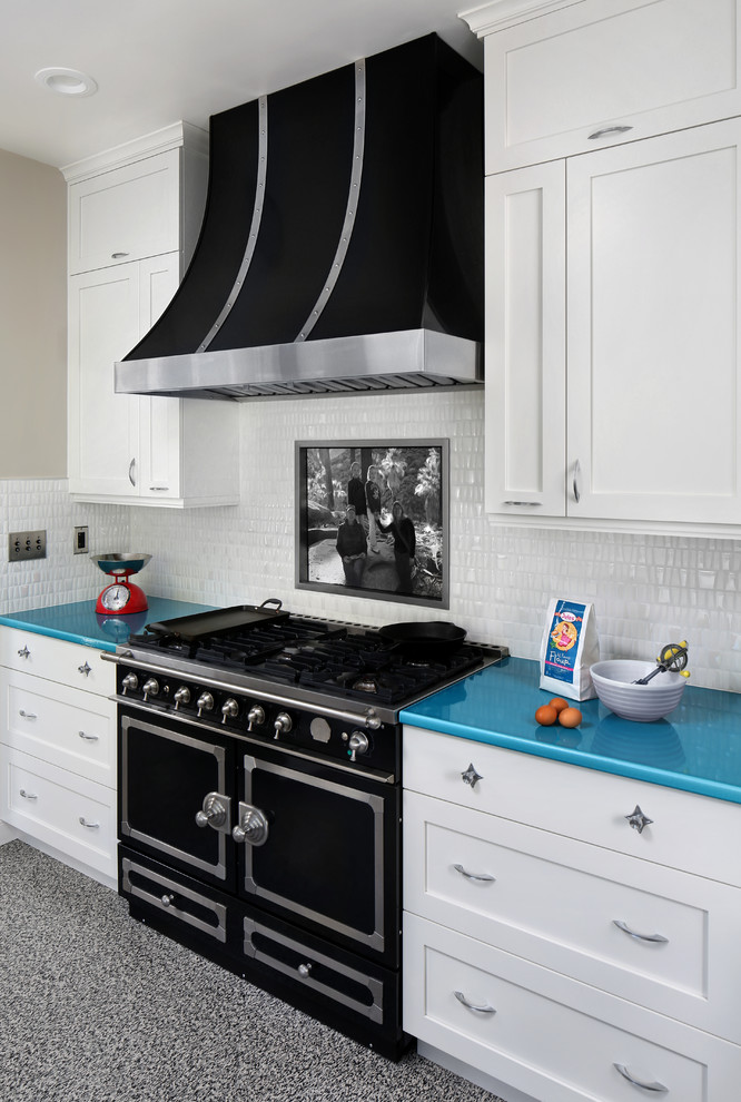 Example of a mid-sized 1950s galley linoleum floor enclosed kitchen design in San Diego with a farmhouse sink, shaker cabinets, white cabinets, white backsplash, ceramic backsplash, black appliances, no island and turquoise countertops