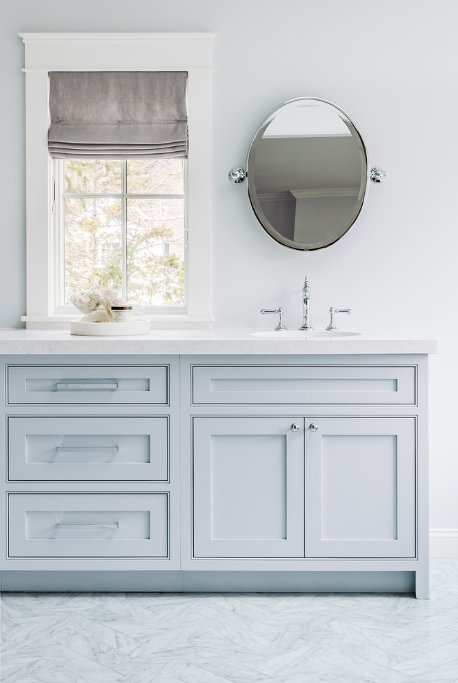 Inspiration for a large traditional master bathroom in Boston with blue walls, marble floors, engineered quartz benchtops, blue cabinets, shaker cabinets and white benchtops.