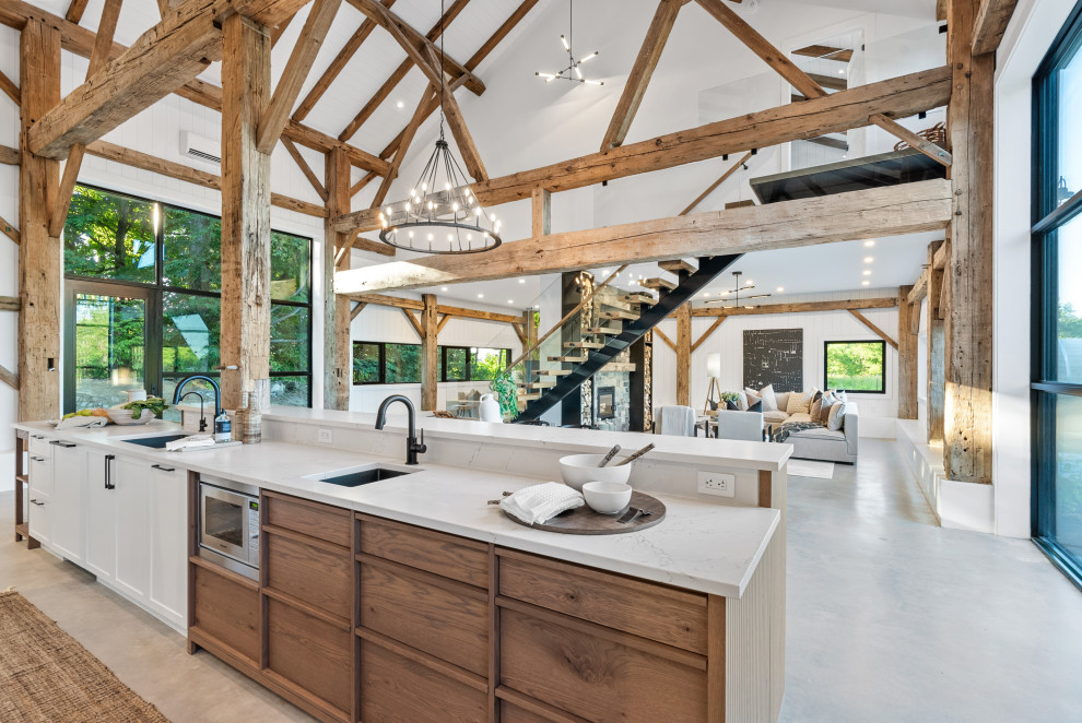 Large transitional galley eat-in kitchen photo with an undermount sink, shaker cabinets, white cabinets, quartz countertops, white backsplash, quartz backsplash, paneled appliances, an island and white countertops