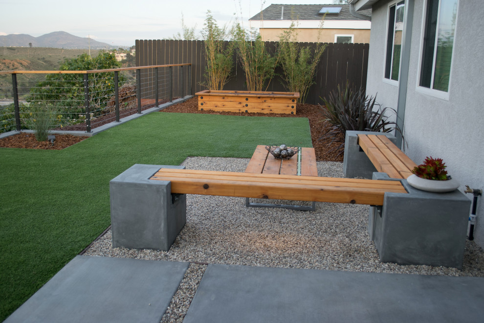Small modern roof partial sun garden for spring in San Diego with a metal fence.