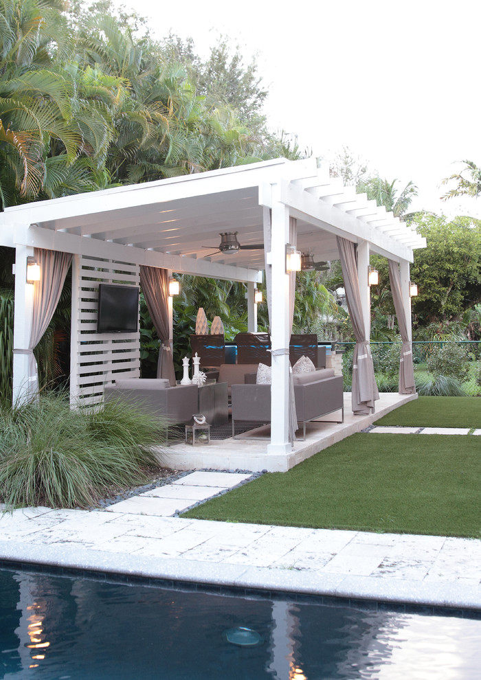 Design ideas for a mid-sized contemporary backyard patio in Miami with an outdoor kitchen, natural stone pavers and a gazebo/cabana.
