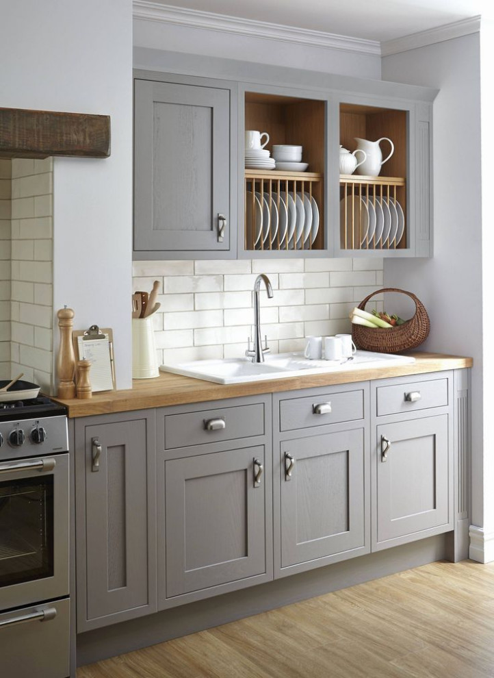 Eat-in kitchen - mid-sized transitional single-wall medium tone wood floor and brown floor eat-in kitchen idea in Columbus with a drop-in sink, recessed-panel cabinets, gray cabinets, wood countertops, white backsplash, ceramic backsplash, stainless steel appliances and brown countertops