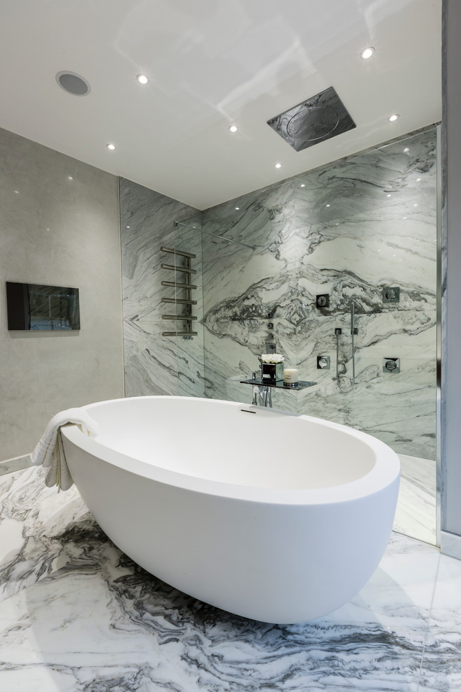 Inspiration for a contemporary bathroom in Surrey with a freestanding tub, a curbless shower, grey walls, marble floors, gray tile, white tile and marble.