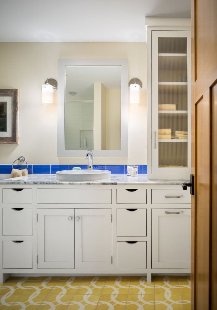 Inspiration for an arts and crafts kids bathroom in Portland Maine with white cabinets, blue tile, glass tile, ceramic floors, shaker cabinets, a drop-in sink, beige walls, quartzite benchtops and yellow floor.