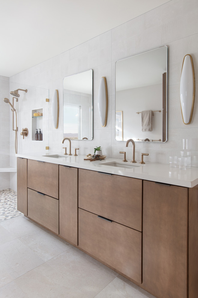 Photo of a large modern bathroom in San Diego with flat-panel cabinets, brown cabinets, a freestanding tub, an open shower, white tile, ceramic tile, porcelain floors, an undermount sink, engineered quartz benchtops, beige floor, an open shower, white benchtops, a double vanity and a built-in vanity.