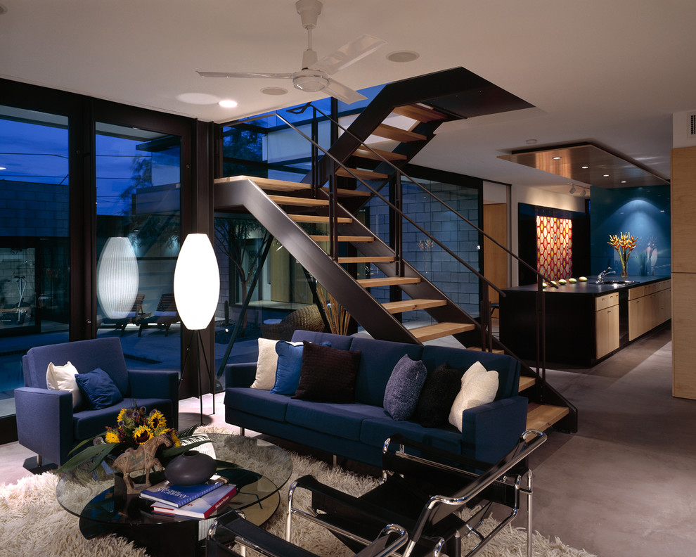 Modern open concept living room in Phoenix with concrete floors.