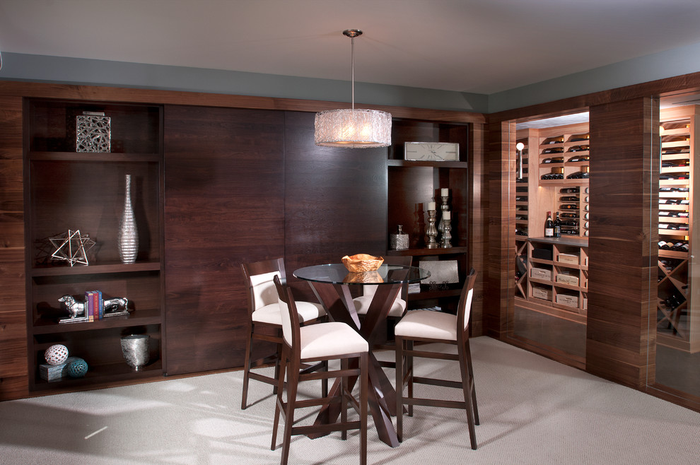 This is an example of a contemporary wine cellar in Grand Rapids with carpet and storage racks.