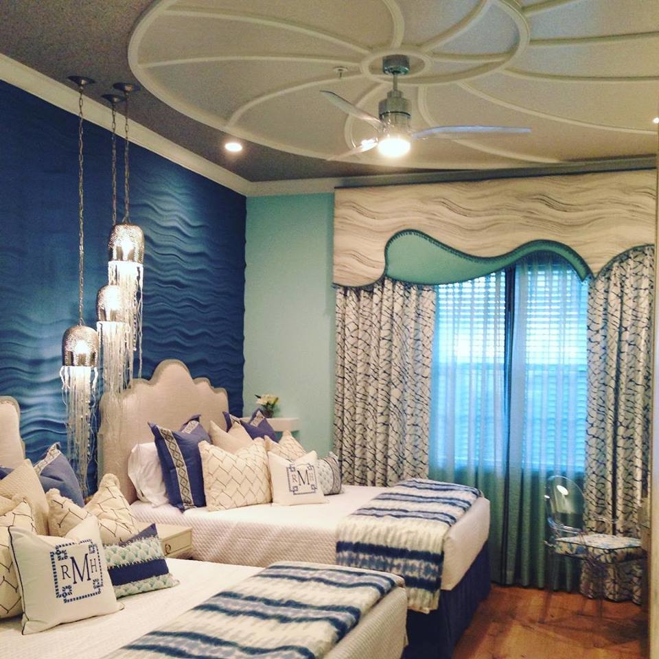 Inspiration for a large beach style guest bedroom in Miami with blue walls and light hardwood floors.