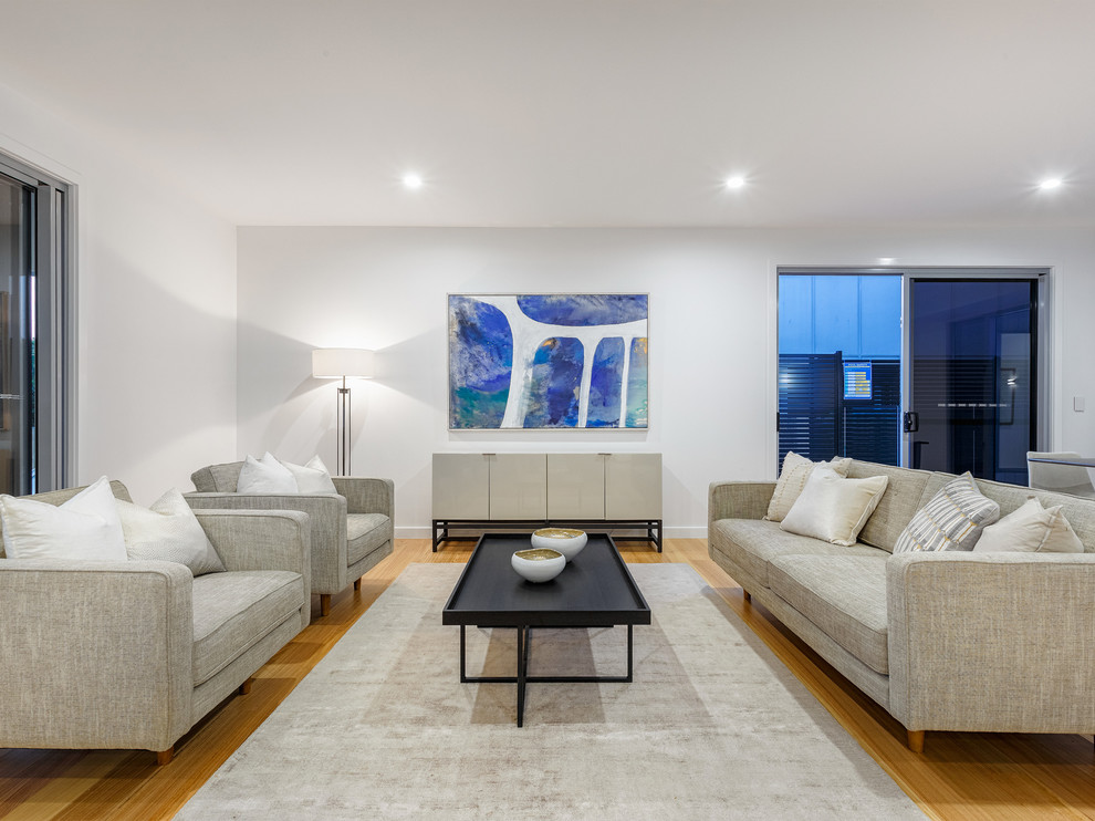Design ideas for a contemporary living room in Brisbane with white walls, medium hardwood floors and brown floor.