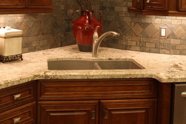 Large l-shaped dark wood floor open concept kitchen photo in Houston with an undermount sink, dark wood cabinets, stainless steel appliances and an island