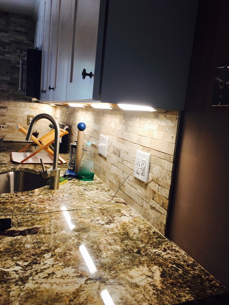 Mid-sized transitional l-shaped medium tone wood floor and brown floor open concept kitchen photo in DC Metro with an undermount sink, shaker cabinets, white cabinets, granite countertops, beige backsplash, stone tile backsplash, stainless steel appliances and a peninsula
