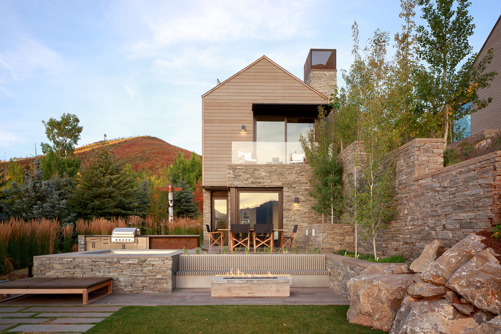 Inspiration for a contemporary two-storey grey house exterior in Denver with wood siding and a gable roof.