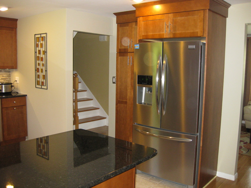 Eat-in kitchen - transitional u-shaped travertine floor and beige floor eat-in kitchen idea in Boston with an undermount sink, medium tone wood cabinets, granite countertops, stainless steel appliances, a peninsula, shaker cabinets, brown backsplash, matchstick tile backsplash and black countertops