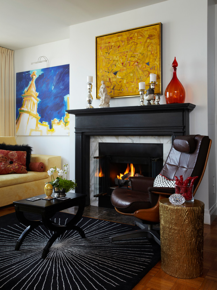 This is an example of an eclectic living room in New York with white walls and a standard fireplace.