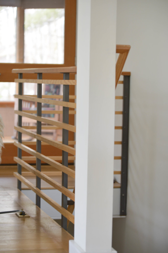 Inspiration for a mid-sized contemporary wood l-shaped staircase in Boston with wood risers and metal railing.