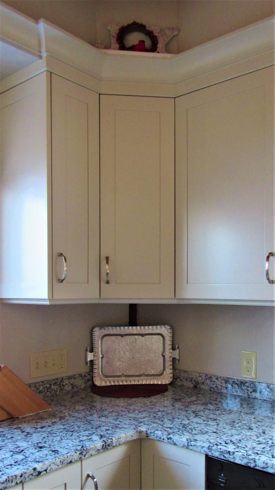 Inspiration for a mid-sized transitional u-shaped eat-in kitchen remodel in Boston with an undermount sink, shaker cabinets, beige cabinets, granite countertops, stainless steel appliances, a peninsula and gray countertops