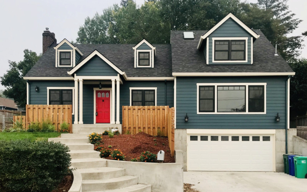 Mid-sized traditional two-storey blue house exterior in Portland with concrete fiberboard siding, a gable roof, a shingle roof, a black roof and clapboard siding.