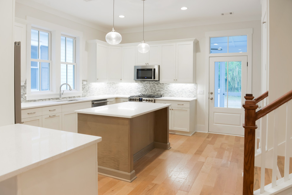 Inspiration for a transitional kitchen remodel with stainless steel appliances and an island