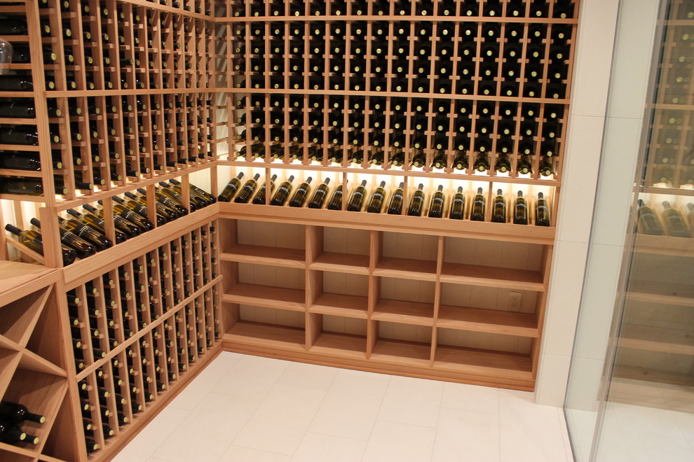 Inspiration for a mid-sized contemporary wine cellar in Orange County with travertine floors and storage racks.