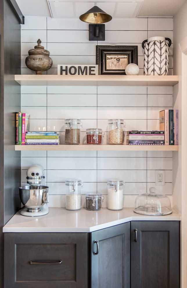 Inspiration for a mid-sized transitional l-shaped light wood floor and beige floor open concept kitchen remodel with an undermount sink, shaker cabinets, gray cabinets, quartz countertops, white backsplash, ceramic backsplash, stainless steel appliances, an island and white countertops