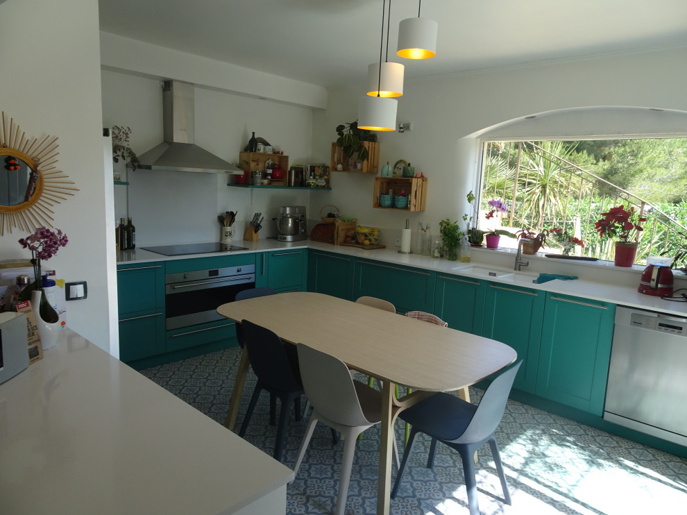 Large traditional l-shaped kitchen in Marseille with an undermount sink, recessed-panel cabinets, turquoise cabinets, quartzite benchtops, white splashback, stainless steel appliances, cement tiles, no island, blue floor and white benchtop.