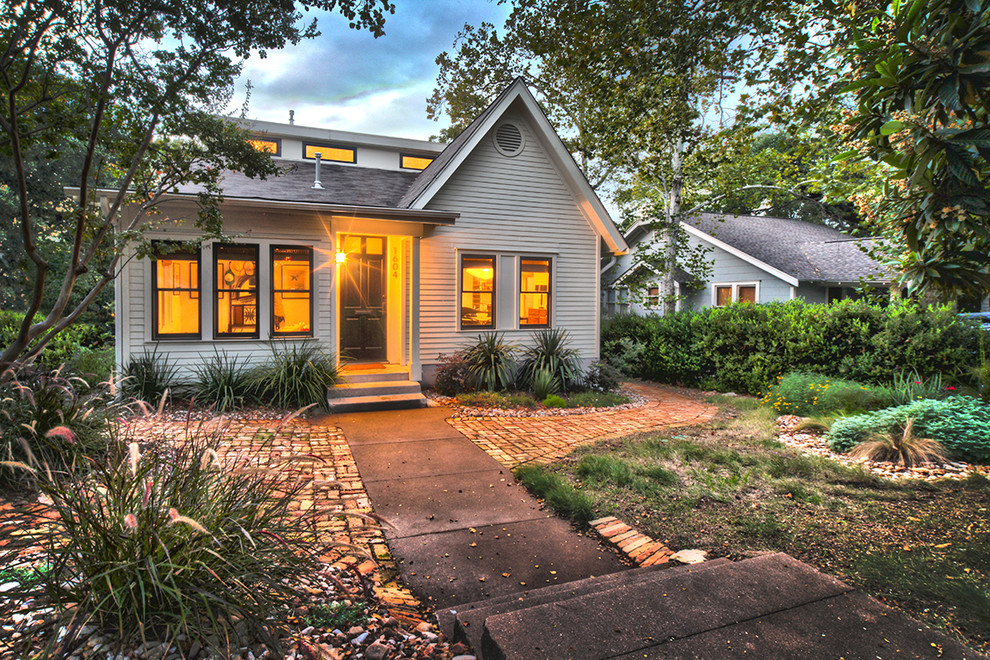 Transitional exterior in Austin with wood siding.