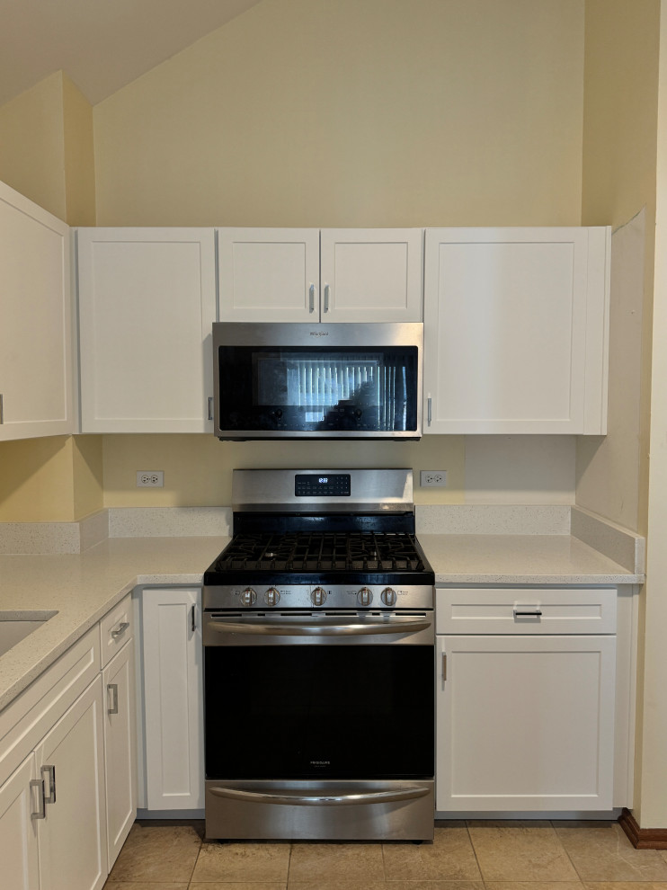 Enclosed kitchen - mid-sized transitional l-shaped enclosed kitchen idea in Chicago with shaker cabinets, white cabinets, quartz countertops and white countertops