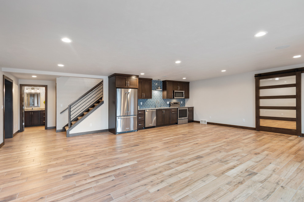 Inspiration for a large transitional walk-out basement in Other with a game room, white walls, ceramic floors, no fireplace and brown floor.