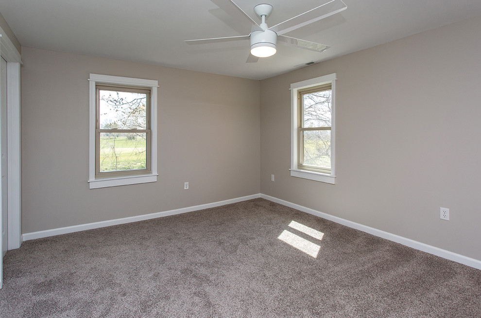 This is an example of a mid-sized country master bedroom in Other with grey walls, carpet and no fireplace.