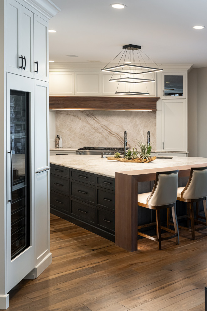Inspiration for a large transitional medium tone wood floor and brown floor open concept kitchen remodel with a double-bowl sink, flat-panel cabinets, white cabinets, quartzite countertops, beige backsplash, stainless steel appliances, an island and beige countertops