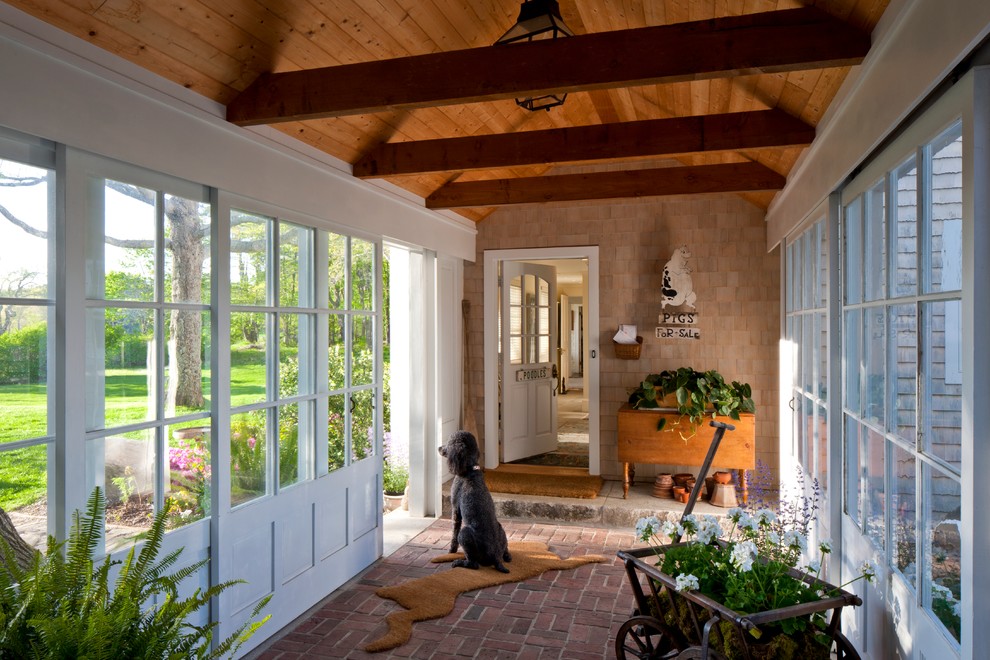 Design ideas for a traditional mudroom in Portland Maine with brick floors.