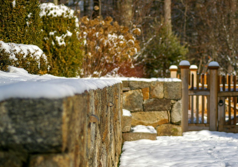 Design ideas for a mid-sized traditional backyard full sun garden for winter in Boston with a retaining wall.