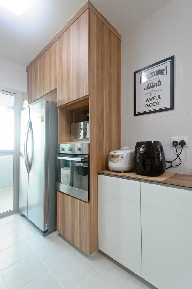 Photo of a scandinavian kitchen in Singapore with a double-bowl sink, flat-panel cabinets, medium wood cabinets, white splashback, ceramic splashback and wood benchtops.