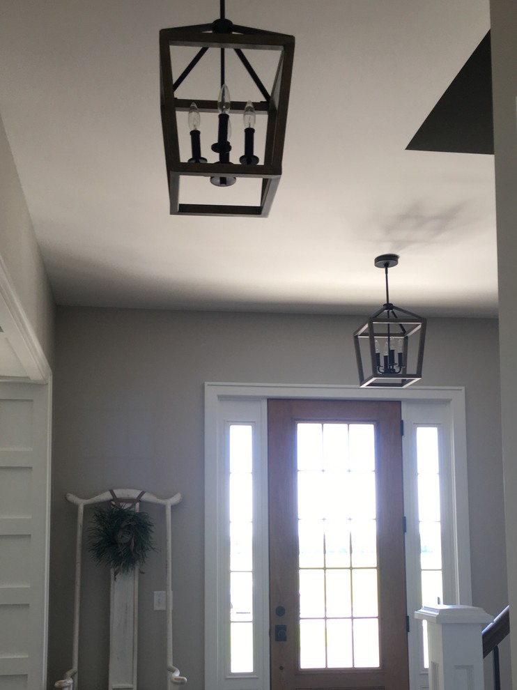 Front door - small transitional front door idea with gray walls and a glass front door