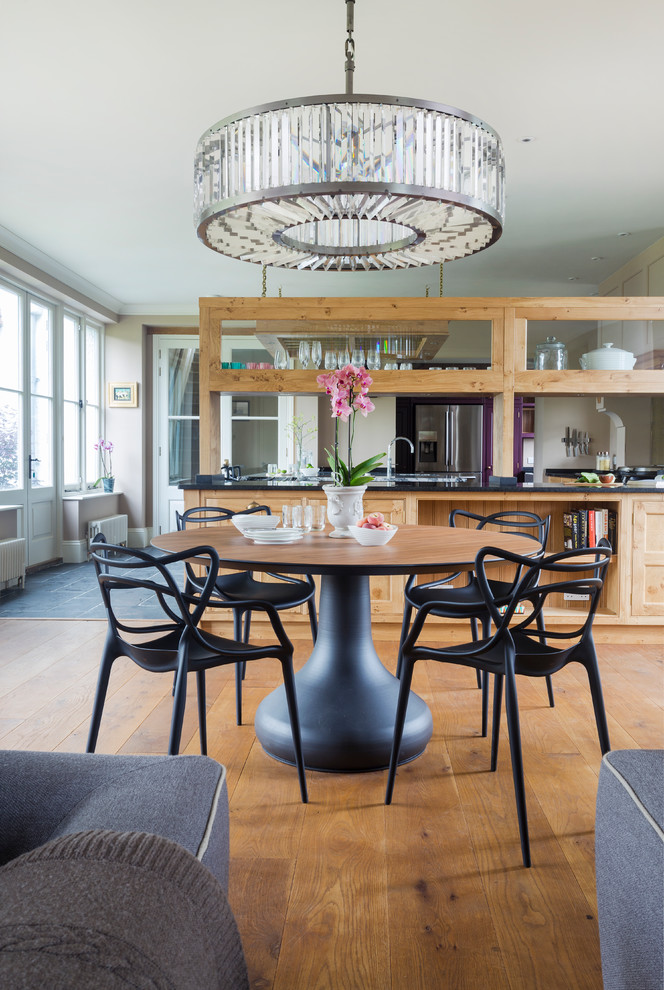 Design ideas for a transitional open plan dining in Hampshire with medium hardwood floors.
