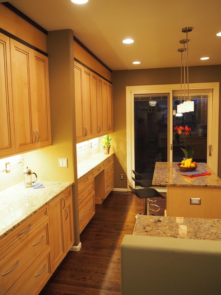 Example of a mid-sized transitional u-shaped medium tone wood floor open concept kitchen design in Denver with an undermount sink, recessed-panel cabinets, light wood cabinets, granite countertops, yellow backsplash, ceramic backsplash, stainless steel appliances and an island