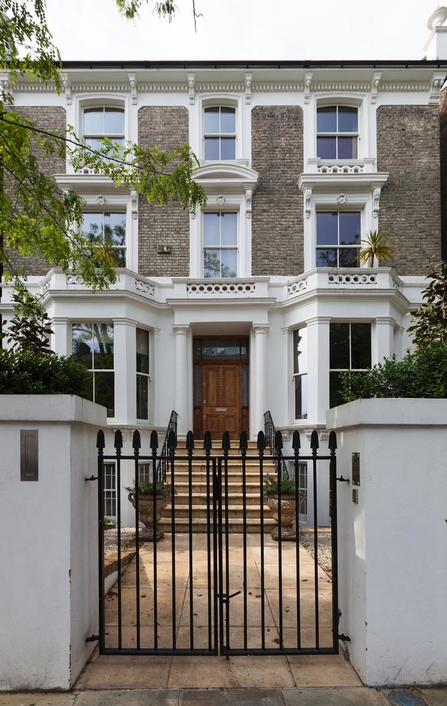 Inspiration for a large contemporary front door in London with white walls, concrete floors, a single front door, a medium wood front door and yellow floor.