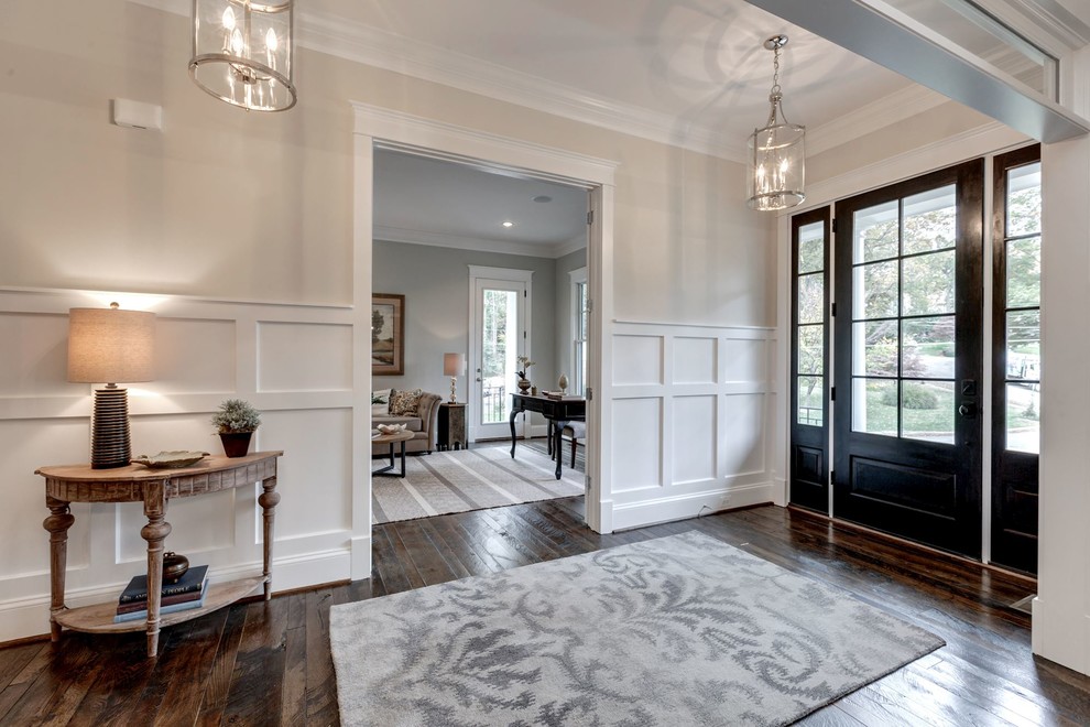 Design ideas for a mid-sized country entry hall in DC Metro with beige walls, dark hardwood floors, a single front door and a dark wood front door.