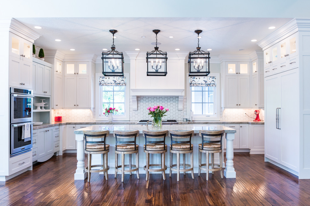 Design ideas for a traditional u-shaped kitchen in Salt Lake City with a farmhouse sink, shaker cabinets, white cabinets, white splashback, panelled appliances, dark hardwood floors and with island.
