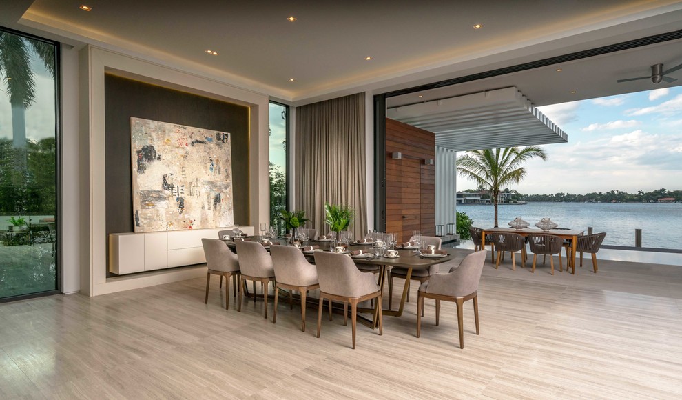 Expansive contemporary open plan dining in Miami with grey walls, beige floor, porcelain floors and no fireplace.
