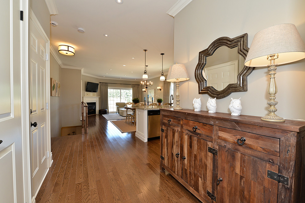 Inspiration for a mid-sized transitional medium tone wood floor hallway remodel in Toronto with beige walls
