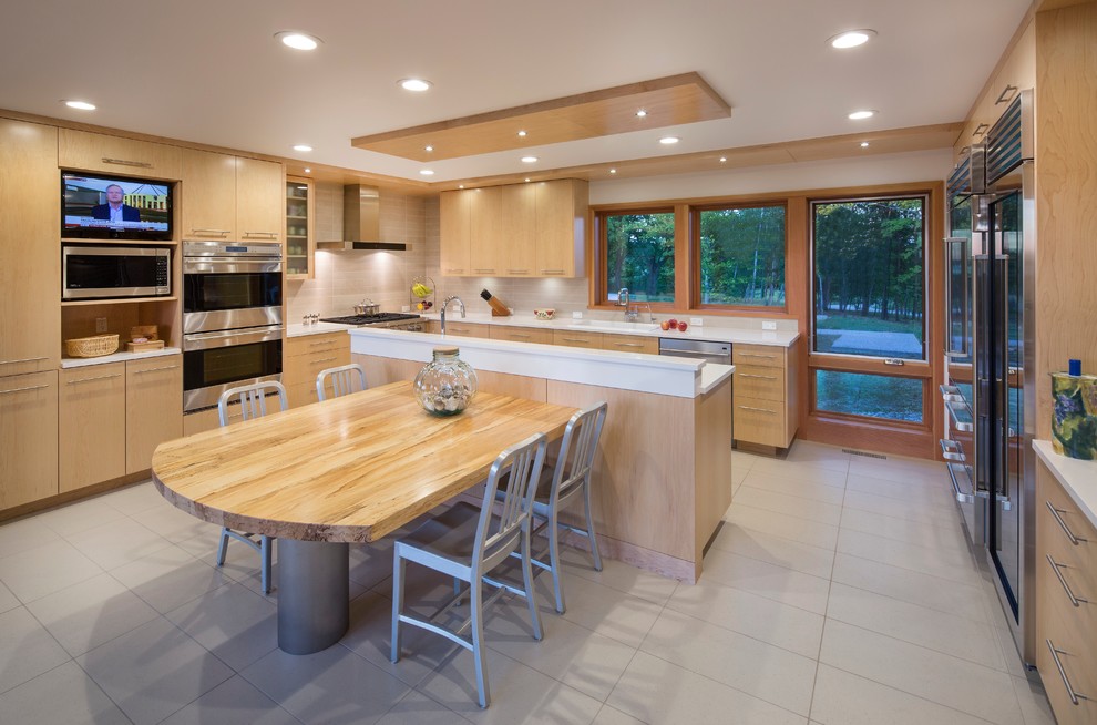 Minimalist u-shaped porcelain tile enclosed kitchen photo with a drop-in sink, flat-panel cabinets, light wood cabinets, quartz countertops, gray backsplash, porcelain backsplash, stainless steel appliances and two islands